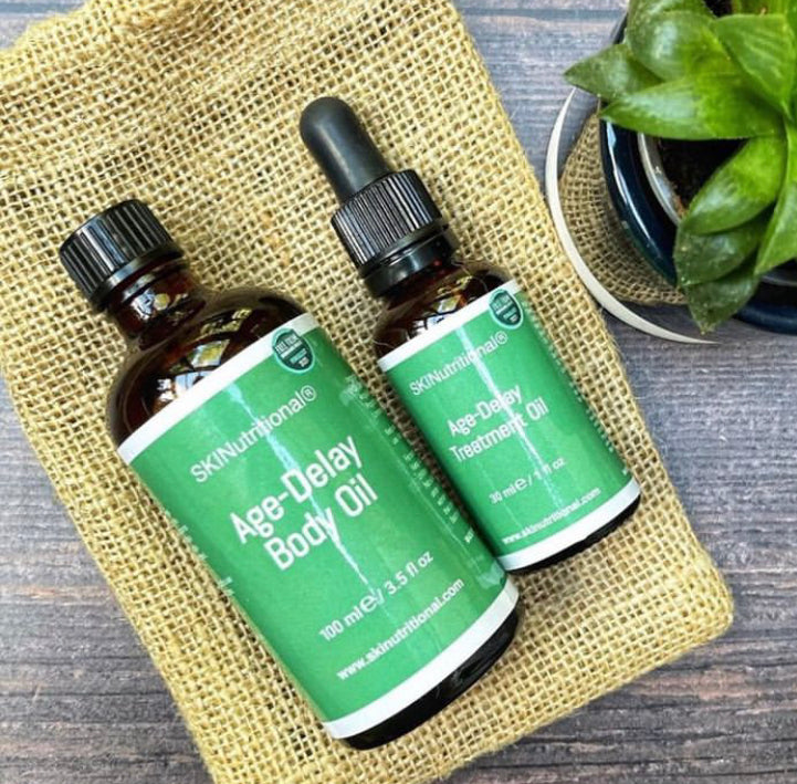 Age Delay SET- Age-Delay Treatment Oil & Age-Delay Body Oil with wooden massage tool in a jute pouch.